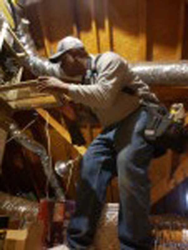 Absolute Home Inspection Service LLC inspector checking roofline and gutters on a Jonesboro property